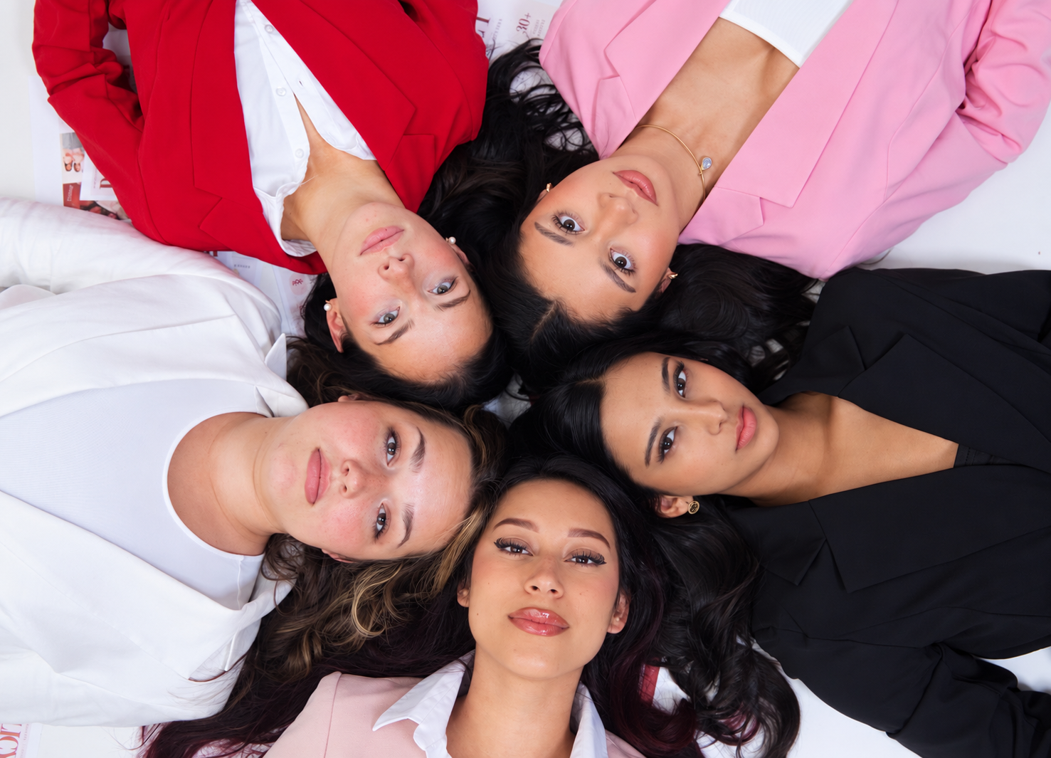 Her Health, Her Future Foundation leaders in coordinated red, pink, black, and white suits