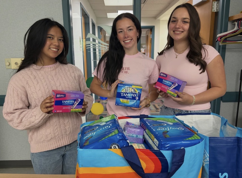 Volunteers collecting period product donations